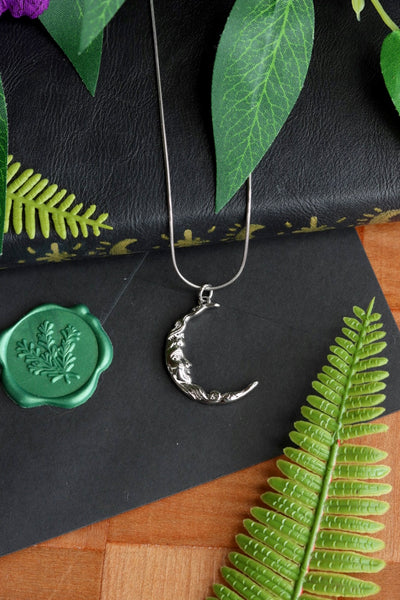 Silver moon face necklace